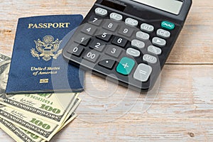 USA passport and 100 dollar notes. Top wiew. Copy space. Concept of recreational and business travel. Calculator to calculate the