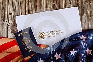 USA passport and naturalization certificate of citizenship US flag over wooden background