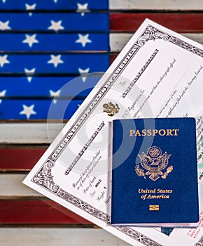 USA passport and naturalization certificate over US Flag