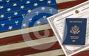 USA passport and naturalization certificate over US Flag