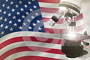 USA science development concept - microscope on flag background. Research in chemistry or biochemistry 3D illustration of object