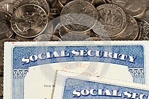 USA Social security cards laid on quarter coins