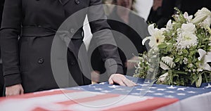USA veteran funeral, woman and casket with touch, sad family and flag for mourning, depression and respect. Widow