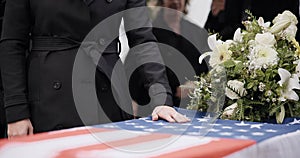 USA veteran funeral, woman and casket with touch, sad family and flag for mourning, depression and respect. Widow