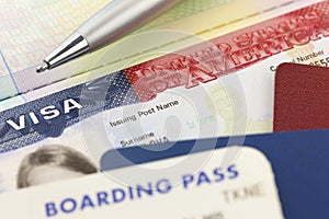 USA Visa, passports, boarding pass and pen - foreign travel