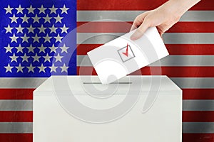 USA Vote concept. Voter hand holding ballot paper for election vote on polling station
