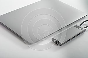 The USB adapter is connected to a laptop with various inputs for a flash drive, hdmi, ethernet, memory card, cables.