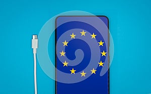 USB-C cable and a smartphone with the European Union Flag on screen