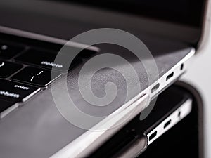 USB-C port of a gray laptop computer. Type C fast charging ports. Computer plug. Connection Concept. Peripheral ports on a PC