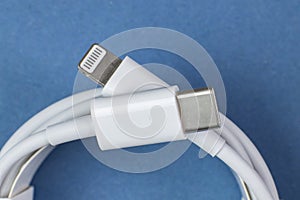 USB-C to Lightning cable on blue, close-up