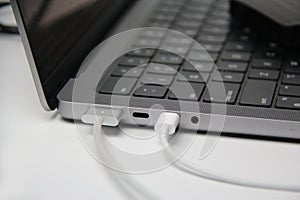 Usb cable connected to laptop, modern personal computer,