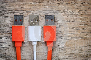 USB cable Plug on wooden background.