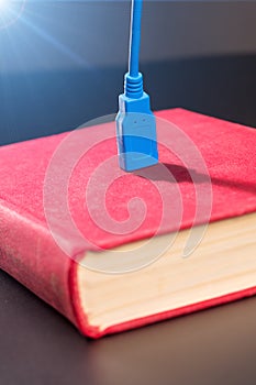 Usb cable plugged into a book