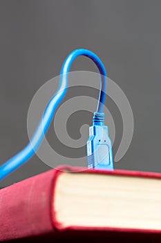 Usb cable plugged into a book