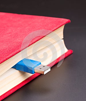 Usb cable sticks out from red book