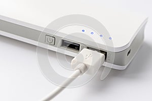 USB cable with USB wall charger plug on a white background. Portable charger close-up