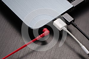 USB cables and headphone jack connected to laptop