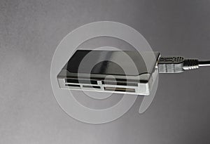 USB card reader on a gray background.