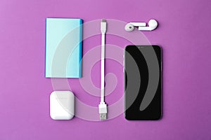 USB charge cable and gadgets on background, flat lay
