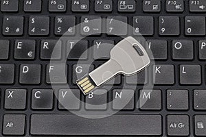 USB flash drive on a black keyboard. Key