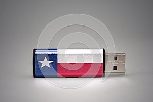 Usb flash drive with the texas state flag of on gray background.