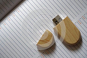 Usb flash drive with wooden surface on note page for USB port plug-in computer laptop for transfer data backup business concept