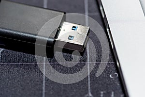 USB flash memory drive plugged into a computer laptop port.