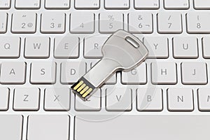 USB key, memory stick on white keyboard