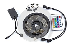 Usb led strip kit. Reel of RGB led strip light with remote control on white background