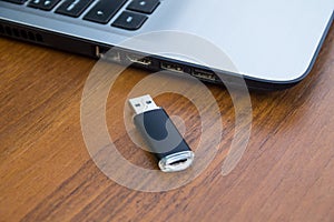 USB memory stick or flash drive and laptop computer