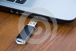 USB memory stick or flash drive and laptop computer