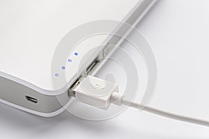 USB plug. Close up of portable battery connected with charging cable. Portable charger