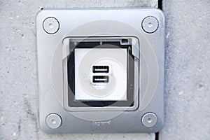 USB ports electronic plug on cement wall