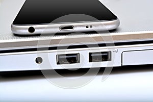 USB ports with smartphone laptop closeup