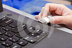 USB stick or USB thumb drive with virus plug in to laptop computer port