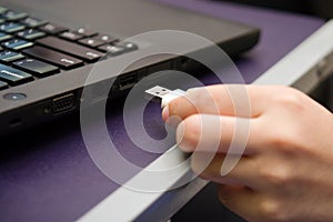 USB stick or USB thumb drive with virus plug in to laptop computer port