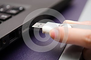 USB stick or USB thumb drive with virus plug in to laptop computer port