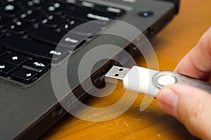 USB stick or USB thumb drive with virus plug in to laptop computer port
