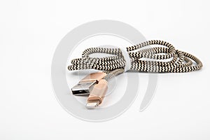 USB to Lightning cable on a white background. Phone accessory, charger and data transfer