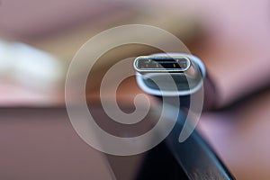 USB Type-C connector next to gadgets on a colored background. Internal pins of the usb type-c connector. Shallow depth of field.