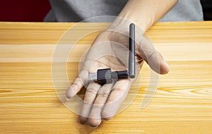 USB wifi black on hand, hand holding usb wifi