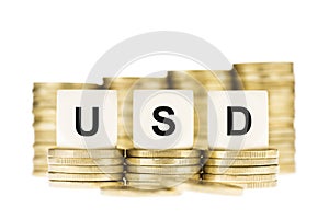 USD (US Dollar) on Stacks of Gold Coins Isolated White
