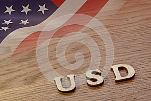 usd word concept made of wooden letters on wooden background with American flag