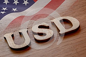 usd word concept made of wooden letters on wooden background with American flag