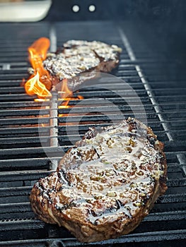 Usda premium ribeye steaks on a grill