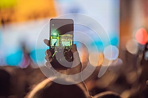 Use advanced mobile recording, fun concerts and beautiful lighting, Candid image of crowd at rock concert, Close up of