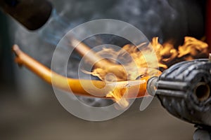 Use of a blowtorch to remove the paint of an orange bicycle fork