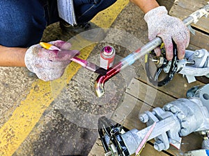 Use a Brush and Apply Liquid Penetrant into the Welding line of stainless steel pipes with process Penetrant Testing(PT)