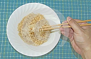 Use chopstick to eat Instant Noodle
