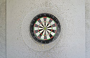 Use classic professional sisal dart board on gray wooden background.